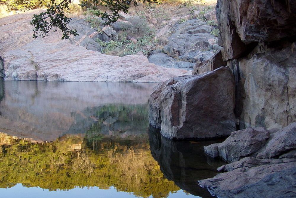 Swim in clear spring-fed waters surrounded by rugged cliffs, or hike to panoramic overlooks and rock climbing spots nearby. Devil's Waterhole | Swimming Hole, Rock Climbing, Hiking | Burnet, Texas